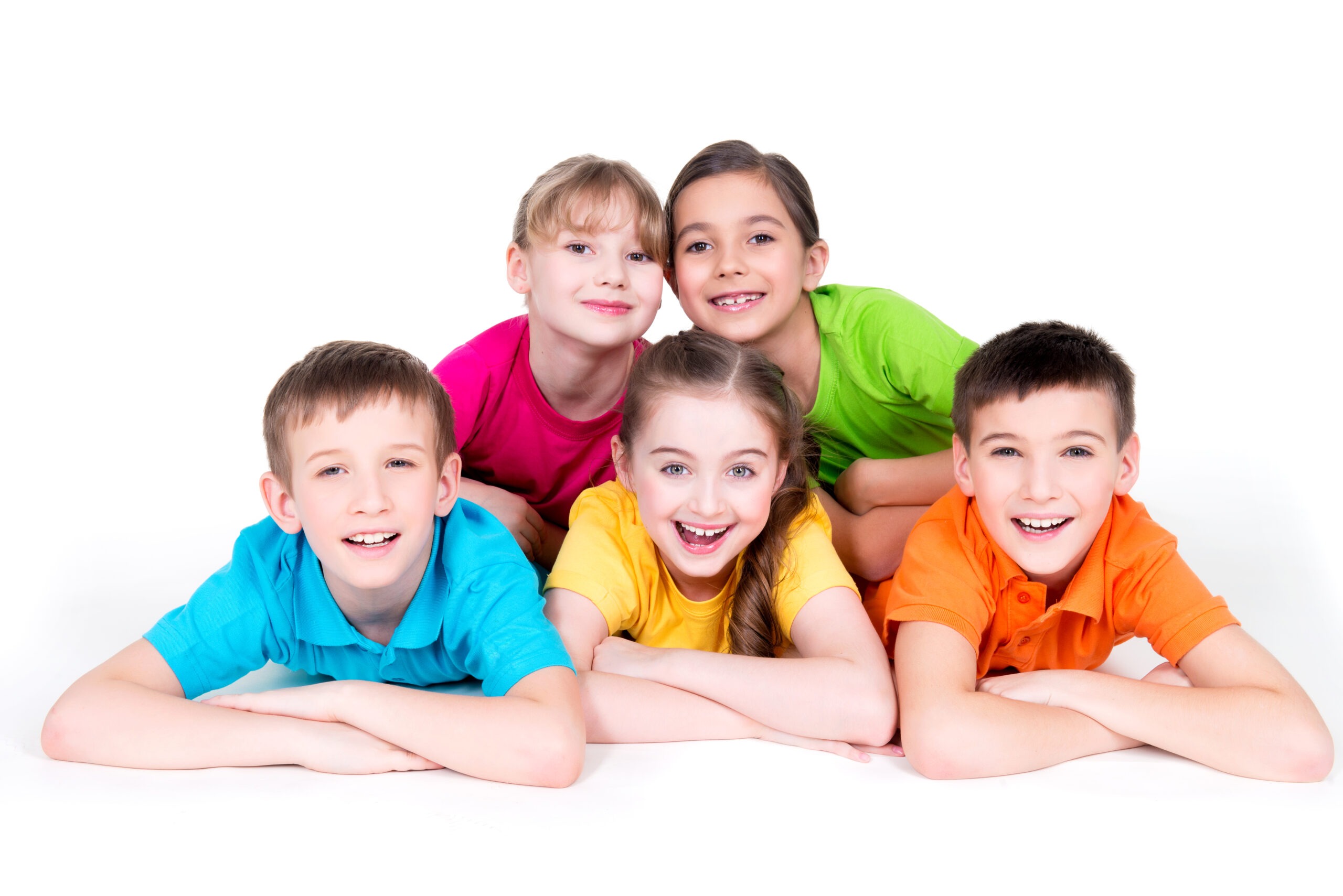 Five beautiful smiling kids lying on the floor in bright colorful t-shirts - isolated on white.